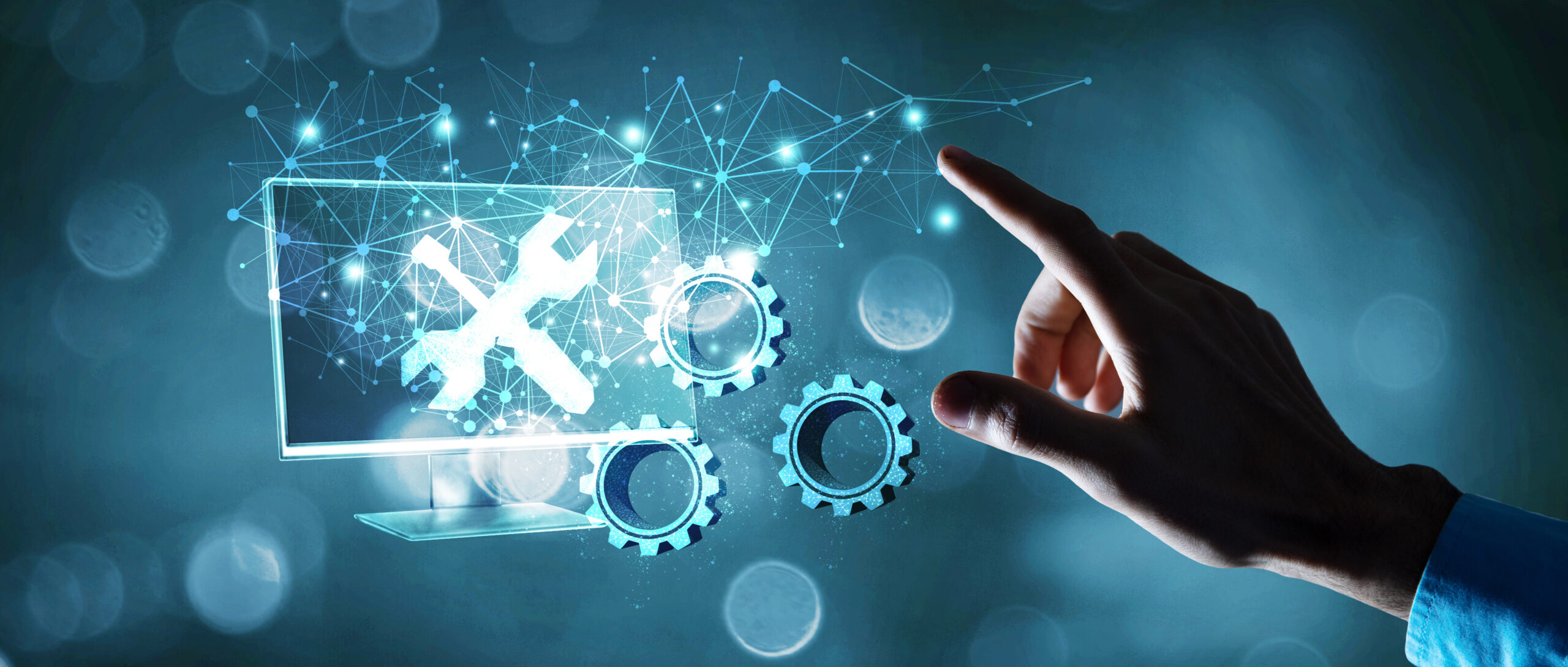 A hand reaches toward a digital screen displaying a wrench and gears, symbolizing technical support and system maintenance for Greencore Group, with abstract network connections in the background.